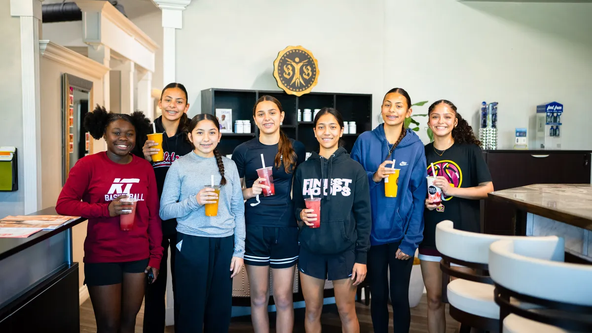 people sitting near table with laptop computer