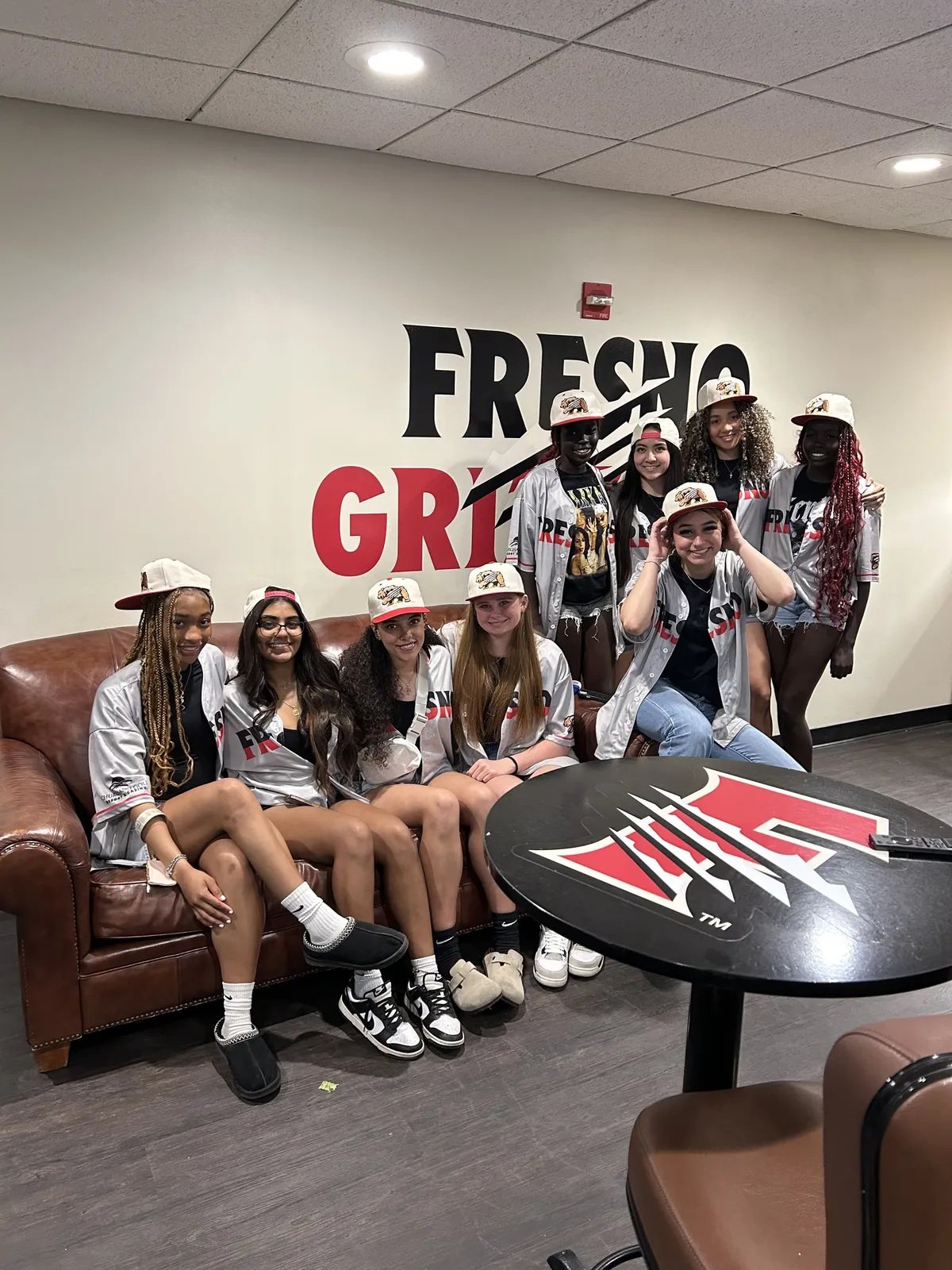 people sitting near table with laptop computer